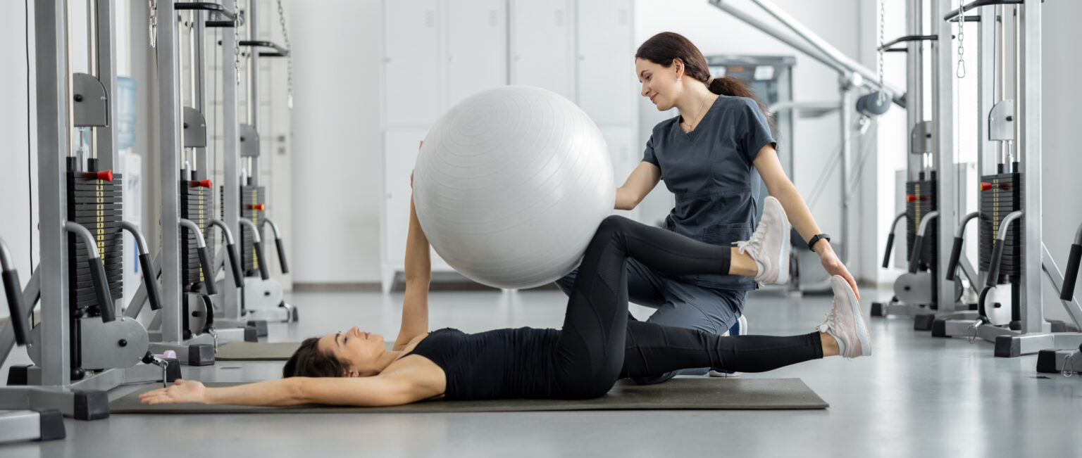 An image of an exercise physiologist performing exercises with a client.